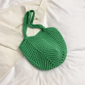 Detailed macro view of vibrant green crochet texture and handmade woven cotton material