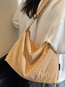 Large beige canvas crossbody travel bag with BNT embroidery for casual daily use