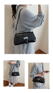 Detailed view of black leather baguette bag featuring a stylish silver square metal buckle