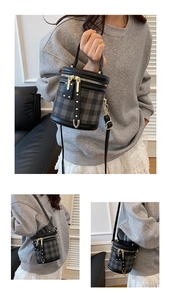 Detail shot of a quilted cylindrical bucket bag with leather handles and gold hardware