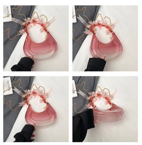 Detail view of pink gradient crescent PVC bag with beaded bows and golden chain strap