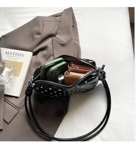 Internal view of the polka dot shoulder bag showing spacious storage for mobile phones