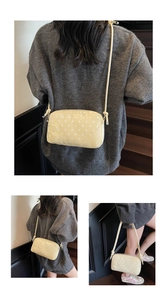 Detail of light yellow polka dot bag showing the 3D letter B and adjustable shoulder strap