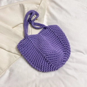 Detailed close-up of purple hand-woven crochet tote bag showing thick textured knit patterns