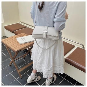 Detail showing high-quality light grey PU leather texture and silver buckle on shoulder bag