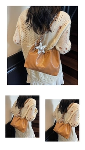 Detailed view of caramel leather shoulder bag featuring a large silver star charm