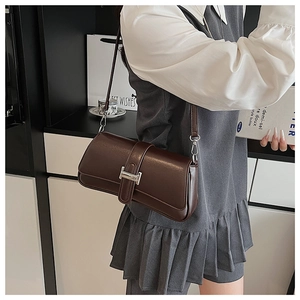 Close-up of dark brown PU leather shoulder bag with metallic H-shaped silver buckle