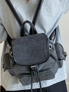 Deep grey canvas backpack with contrast stitching and leather handles for school and casual use