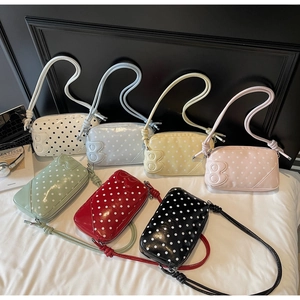 Detailed top view of trendy polka dot crossbody bags in seven vibrant colors