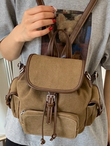 Vintage canvas backpack with brown leather trim and large capacity for school and travel