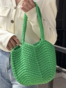 Handmade green crochet tote bag for summer beach holidays featuring a thick woven texture