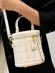 Chic quilted cylindrical bag in beige with gold hardware and a top handle style