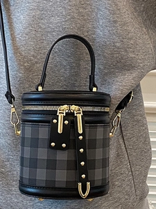 Chic black and grey quilted barrel bag with gold hardware and detachable shoulder strap