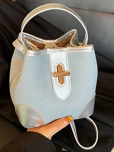Fashionable light blue and silver bucket bag with gold twist lock and handle
