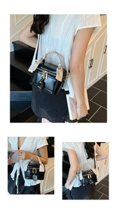 Detail of black patent leather mini box bag with gold hardware and silk scarf on handle
