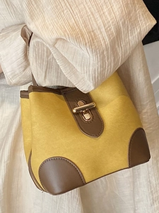 Chic yellow and brown bucket bag with gold twist lock and adjustable shoulder strap