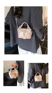 Pink retro bucket bag with scarf-wrapped handle and adjustable strap shown on model