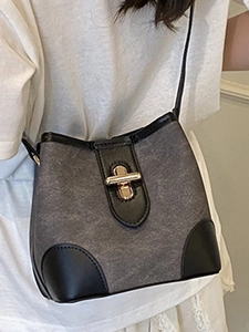 Chic two-tone bucket bag with gold lock and black leather trim for women