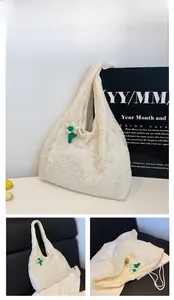 Close-up of white lace floral canvas tote bag featuring green and white flower decoration