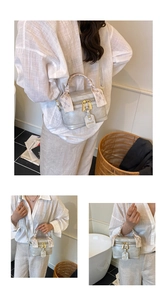 Detailed macro view of a silver metallic bucket bag with silk scarf handle and gold hardware