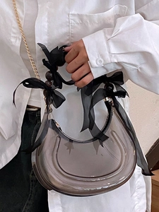 Fashionable grey transparent crescent moon bag with black bows and golden chain strap