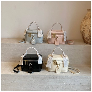 Detailed grid view of stylish leather bucket bags with silk scarf wrapped handles