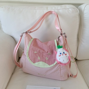 Pink nylon shoulder bag featuring a watermelon design cover and dragon fruit plush pendant