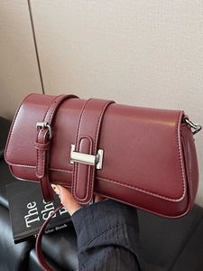 Minimalist wine red leather baguette bag with silver buckles and slim shoulder strap