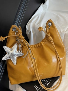 Chic mustard yellow pleated tote bag with drawstring straps and silver star pendant charm