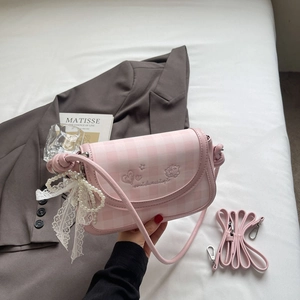 Detailed shot of pink plaid shoulder bag with pearl charm and sweet embroidery detail