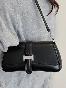 Minimalist black PU leather underarm bag featuring a silver metal H-shaped buckle detail