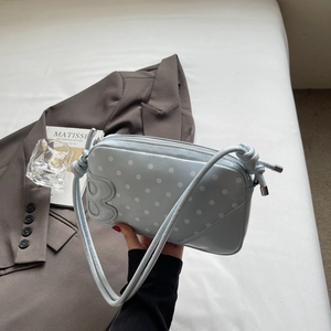 Detail of light blue polka dot bag with B leather patch and slim double shoulder straps