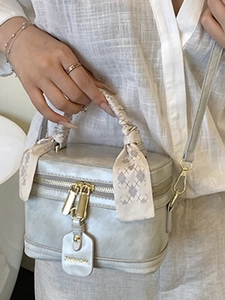 Chic silver box-style bucket bag with a silk scarf handle for a trendy summer look