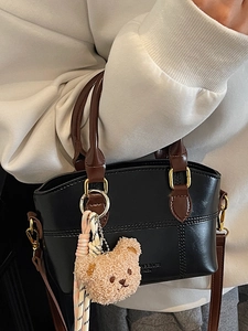 Mini-Umhängetasche aus schwarzem Leder mit braunem Besatz und süßem Teddybär-Anhänger