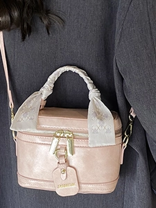 Pink lychee grain bucket bag with silk scarf handle and brand tag for daily casual wear