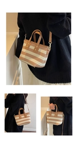 Detail of hand-woven striped bucket bag with leather strap and gold rivet accents