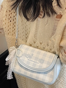 Blue and white checkered shoulder bag with embroidery and pearl lace charm on model