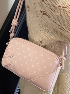 Chic pink polka dot shoulder bag for women with decorative B-logo and knotted strap