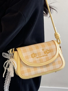 Yellow plaid shoulder bag with embroidery and pearl lace charm shown on model