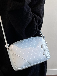 Blue polka dot crossbody bag with 3D B logo and adjustable knotted shoulder strap