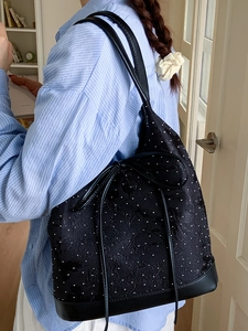 Chic black underarm tote bag with white polka dots and delicate floral patterns