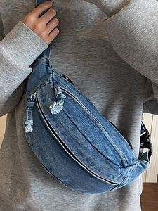 Sac bandoulière en denim bleu en forme de croissant avec fermeture éclair en métal