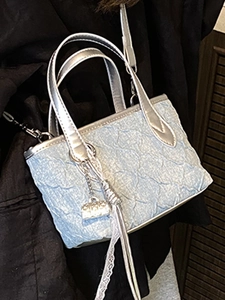 Fashionable mini square handbag in light blue pleated fabric with silver handles and lace detail