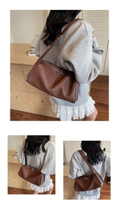 Detail view of the brown lychee pattern leather shoulder bag with dual zipper closure