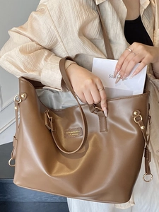Brown large capacity PU leather tote bag for women featuring polished metal logo detail