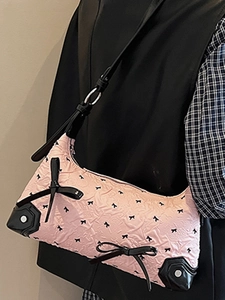 Chic pink underarm bag with black bow patterns and silver rivets for 2025 summer