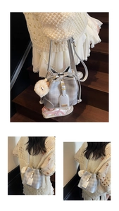 Detail of silver checkered bucket bag with drawstring and white plush monster charm
