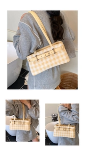 Detail of yellow gingham shoulder bag with leather buckle and soft canvas texture