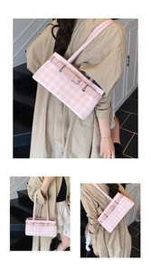 Close-up of pink and white checkered shoulder bag with silver metallic belt buckle detail