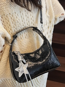 Sac bandoulière en cuir verni noir brillant avec pendentif étoile et texture plissée